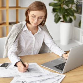 elegant-businesswoman-dressed-formally-sitting-with-laptop-1