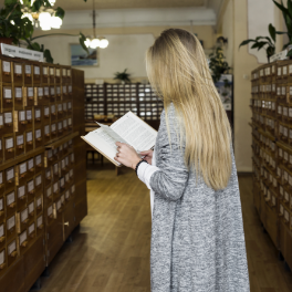 unrecognizable-woman-reading-library